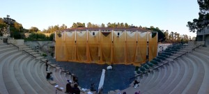 Sheer saffron-colored fabric drapes the Getty Villa museum facade for SITI Company's production of Aeschylus's 