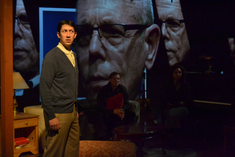 Christian T. Chan (with Joe Spano on video) in Jesse Me-En Shao's The End Times (photo by Playwrights' Arena)